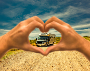 hands shaped like a heart framing an rv because here are 5 Tips for a Successful RV Trip