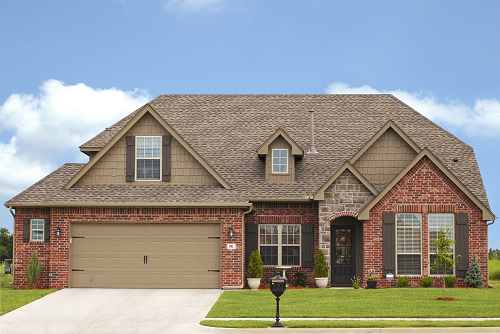 a large brick building with grass in front of a house